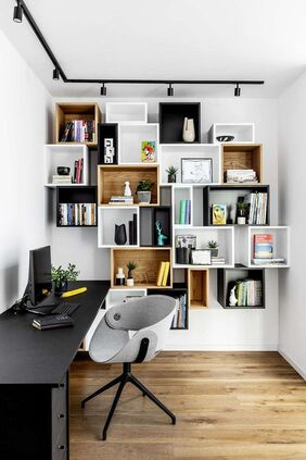 15 mismatching box wall mounted shelving units double as decoration in a home office